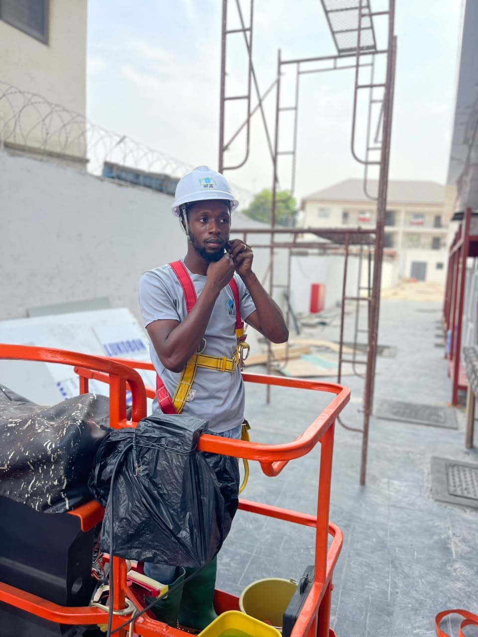 HFJS team cleaning glass and surfaces after construction, Accra